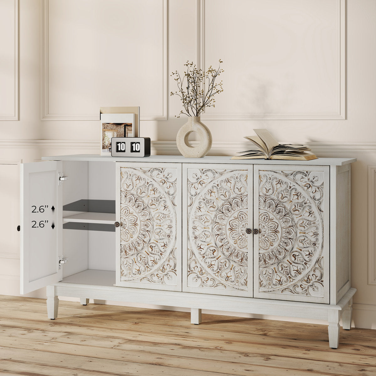 White carved sideboard with one door open showing adjustable shelf