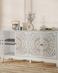 White carved sideboard with one door open showing adjustable shelf