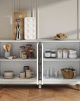 White carved sideboard with all doors open showing storage