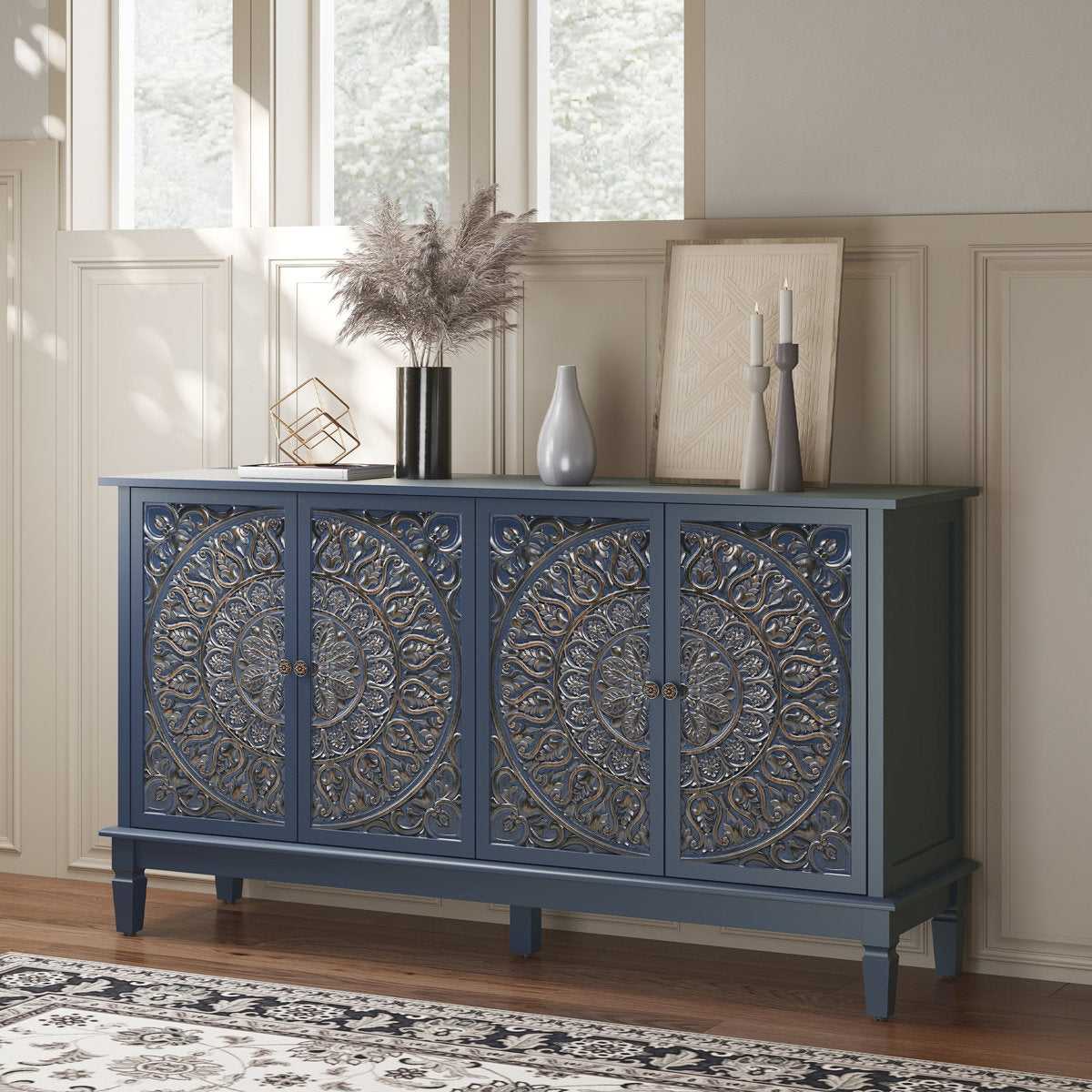 Blue carved sideboard styled by a window