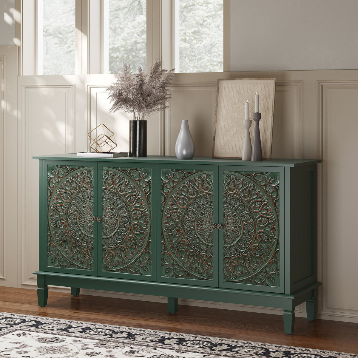Green carved sideboard styled by a window