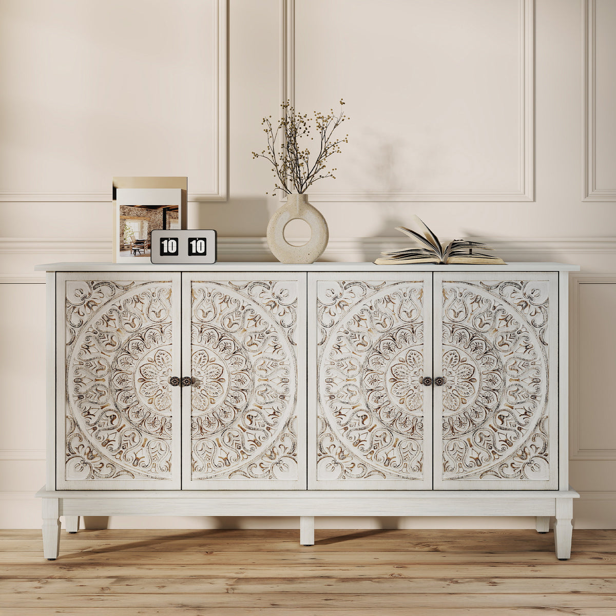 White carved sideboard with four floral-carved doors in a panelled room