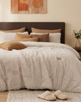 Beige plush faux fur comforter set on a bed