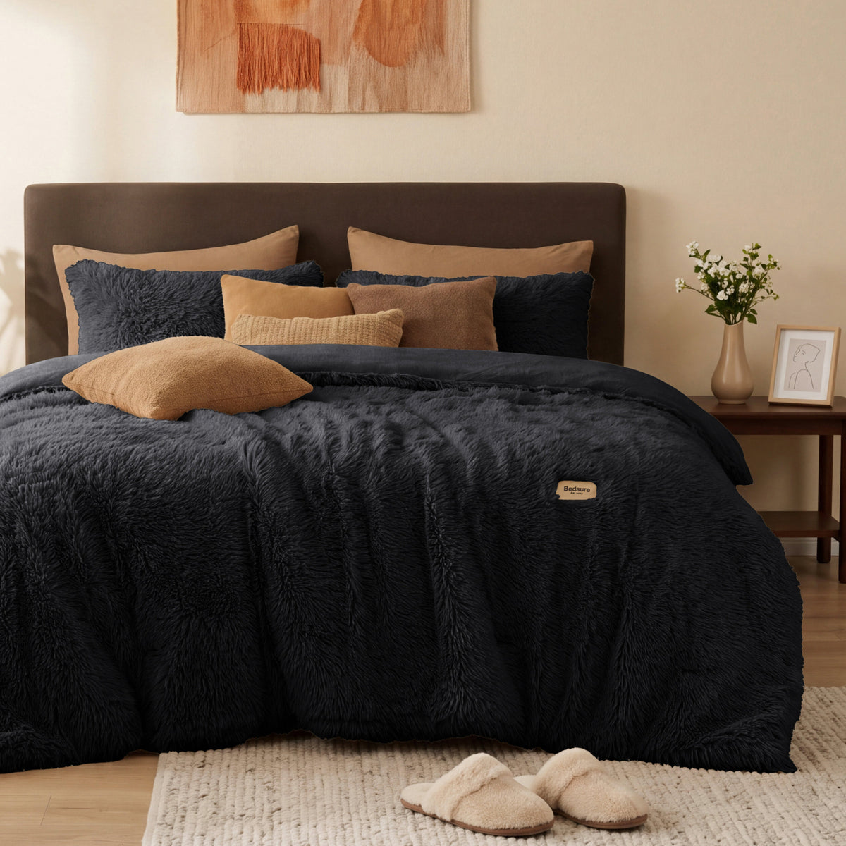 Black plush faux fur comforter set on a bed