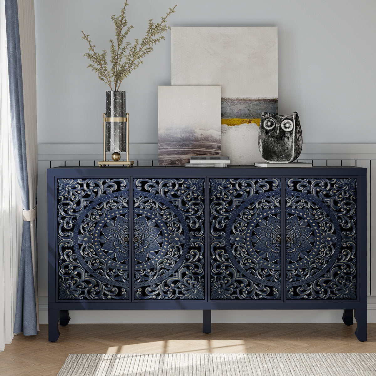 Carved navy blue sideboard with four floral-carved doors, styled with art
