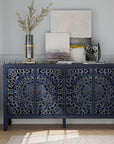 Carved navy blue sideboard with four floral-carved doors, styled with art