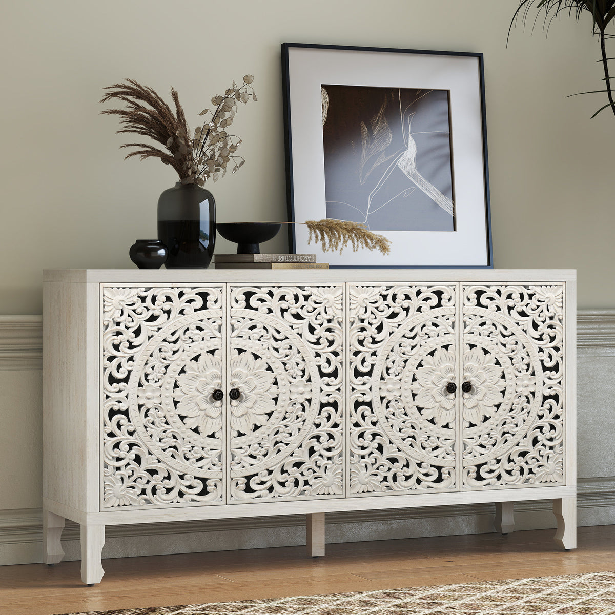 Carved white sideboard with four floral-carved doors, styled with vases and framed art