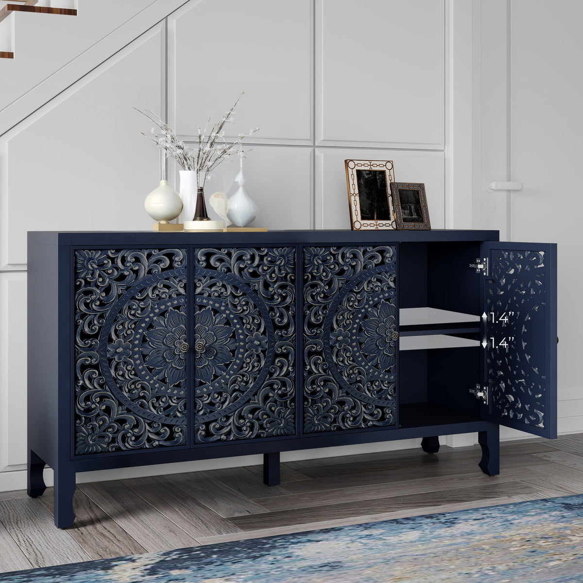 Carved navy blue sideboard in an entryway with one door open
