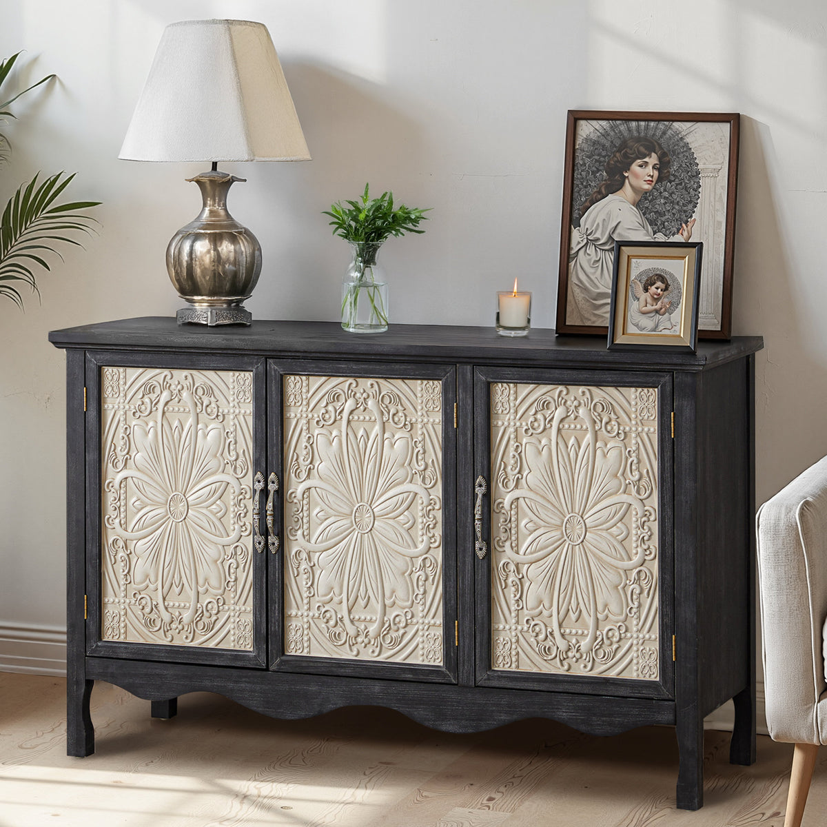 Black Irim accent cabinet with cream carved doors, styled with a lamp