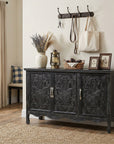 Distressed black Irim accent cabinet in an entryway