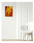 An abstract painting of a tiger in vibrant orange, yellow, and red tones, displayed on a textured white wall in a modern room setting with a white chair and curtains.
