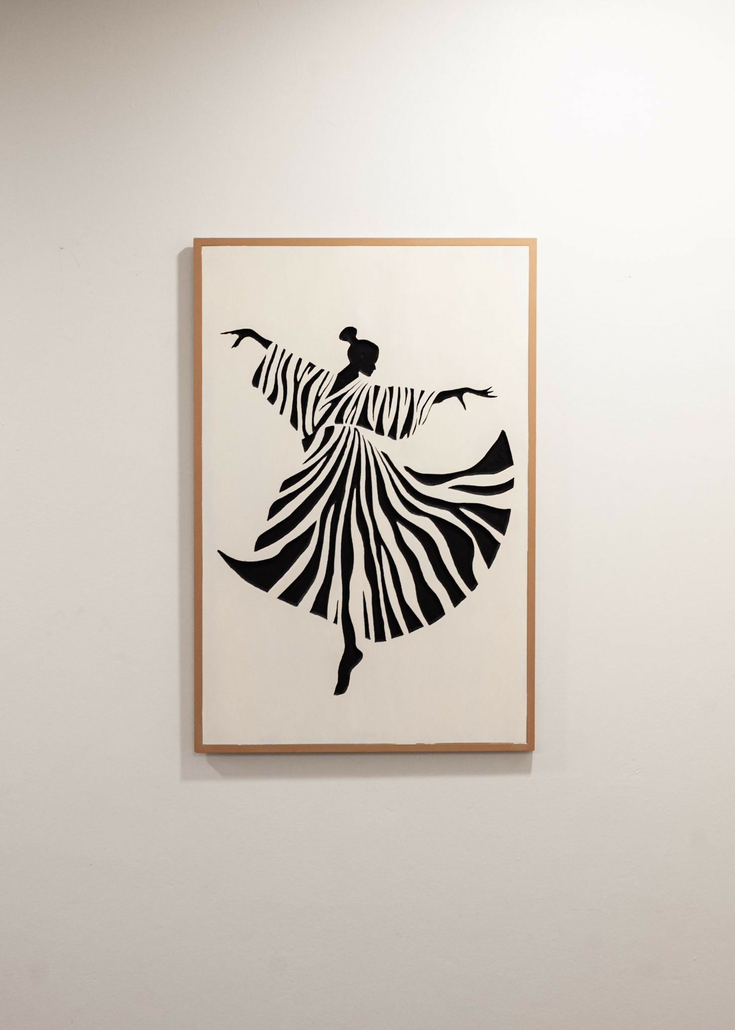 Caribbean Marketplace Art - Framed wall art featuring a black silhouette of a dancing figure with a zebra-stripe patterned dress, displayed on a light neutral wall. 