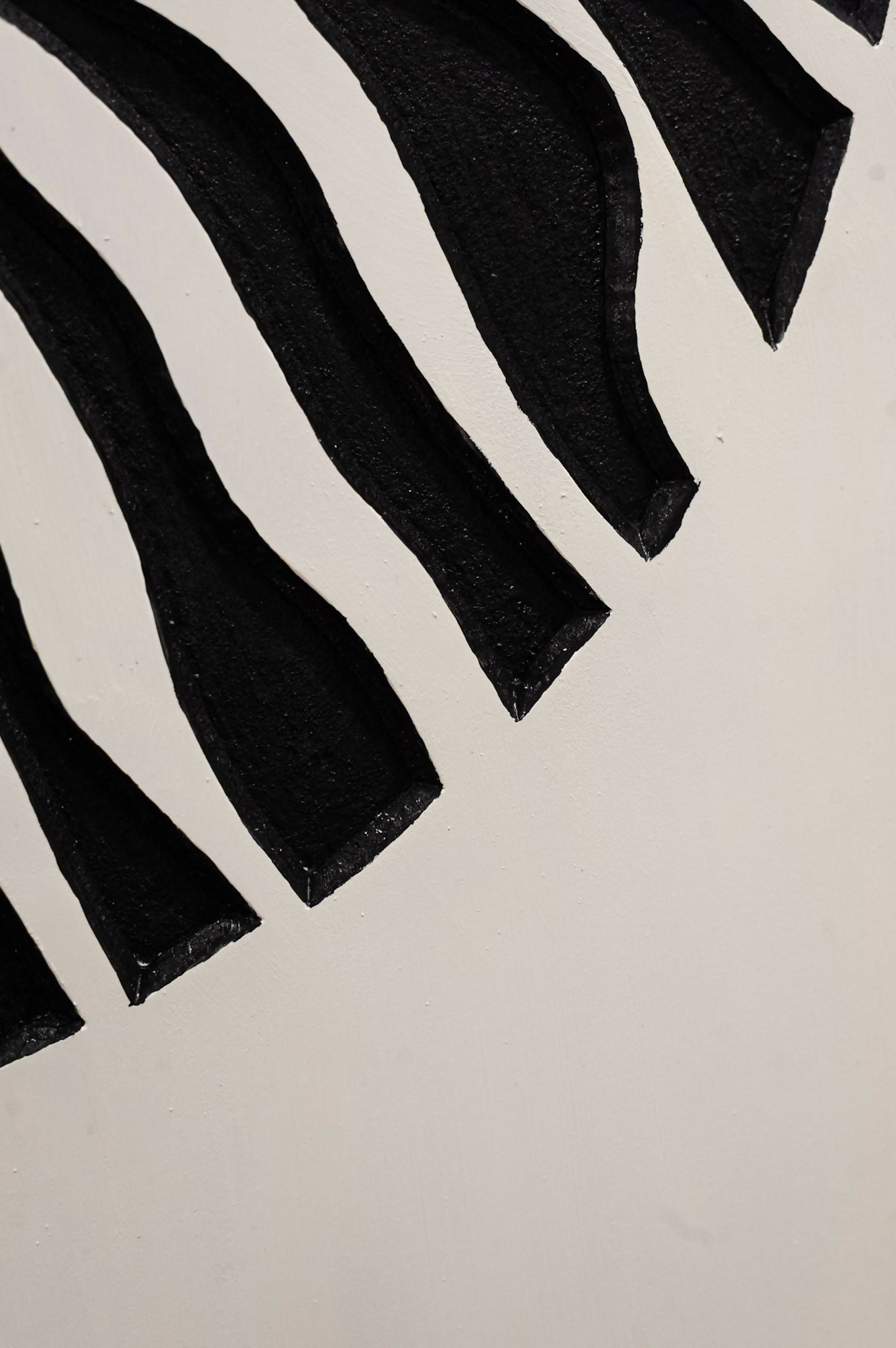 Jardine Marketplace Caribbean Art - A close-up of a black and white pattern featuring bold, wavy black stripes on a white background.