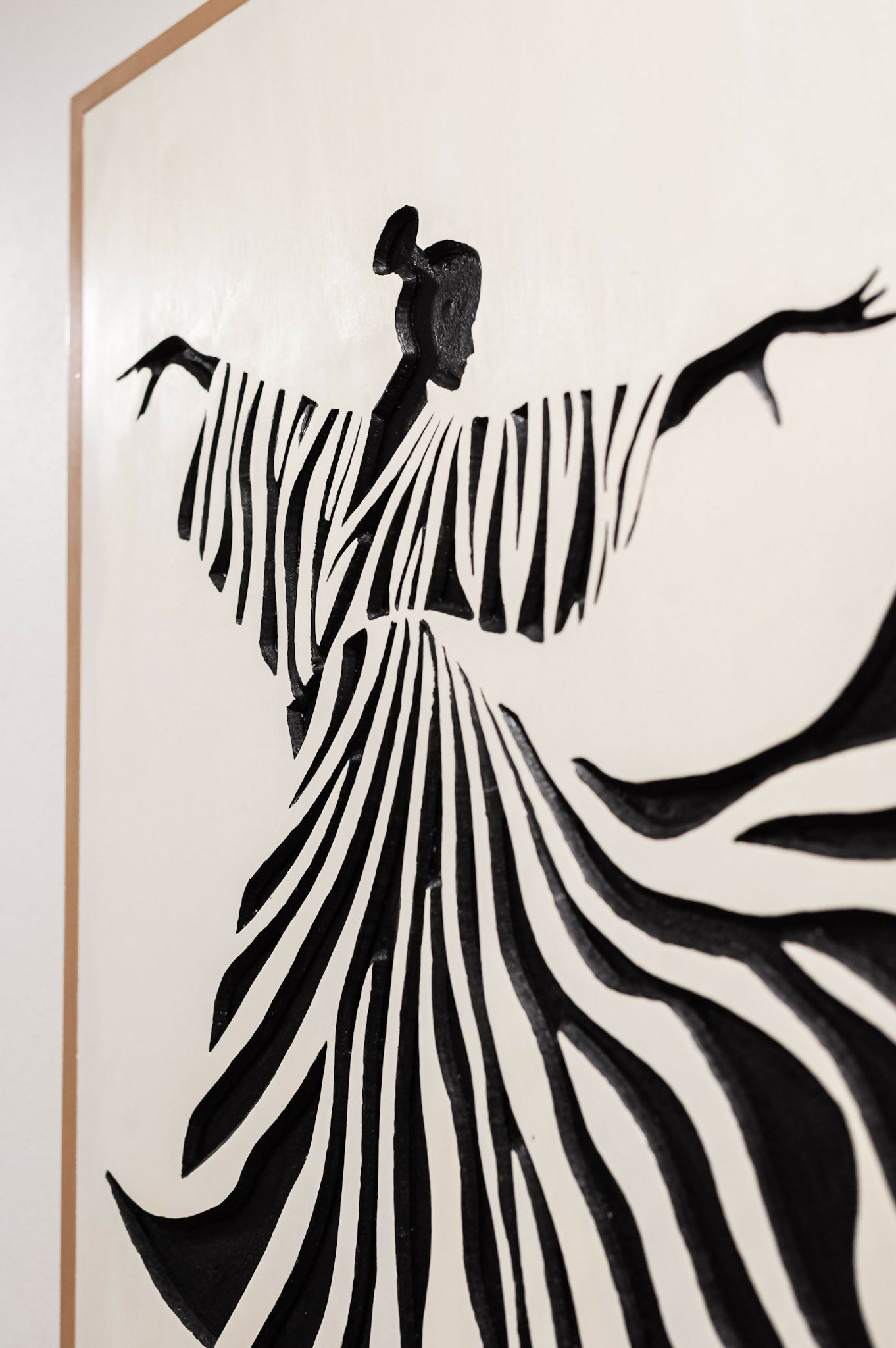 Jardine Marketplace Caribbean Art - A black and white art print depicting a stylized figure in a flowing striped garment, shown against a white background with a thin tan frame edge visible.